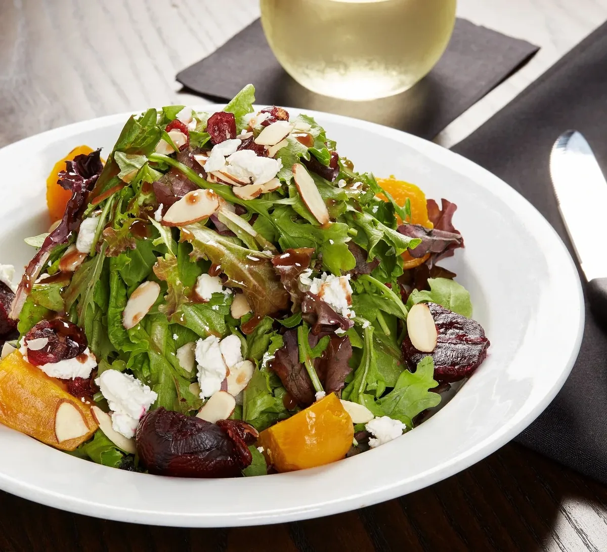 Beet salad with goat cheese, sliced almonds and cranberries